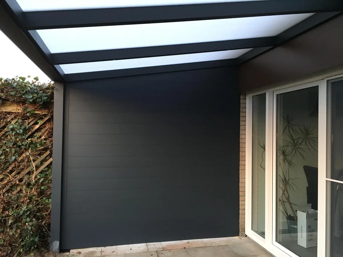 Anthracite Grillo side panel fitted beside a house under a veranda roof